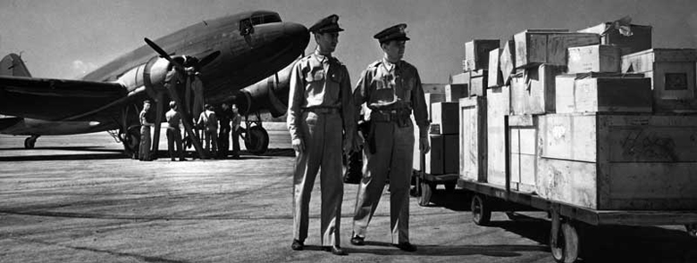 Pan Am airplane and military personnel at MIAD ready to transport cargo in support of the North African campaign. June 5, 1943. Photo by Robert Yarnall Richie. Miami News Collection, HistoryMiami. 1989-011-10082.
