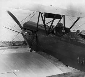 A photographer, probably Richard Hoit, holds his camera while seated in a biplane. May 5, 1929. HistoryMiami. Hoit C9825.
