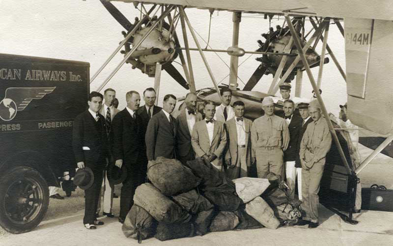 Pan Am employees pose with mail sacks at the inaugural Miami to Buenos Aires airmail flight. 1920s. HistoryMiami. x-1784-1.